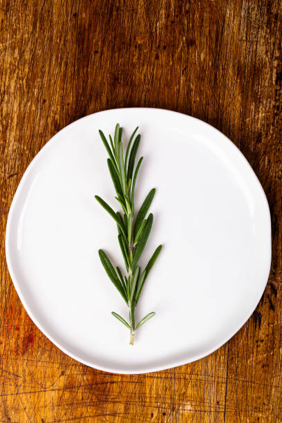 istock Fresh Rosemary on wooden background 1073906756