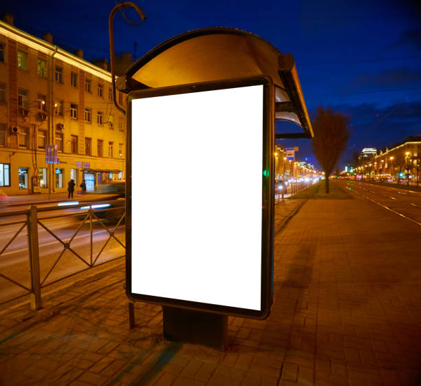 Billboard on the street glows at night. Layout for advertising design. Lightposter pylon with a white field. bus shelter Outdoor Advertising bus shelter stock pictures, royalty-free photos & images