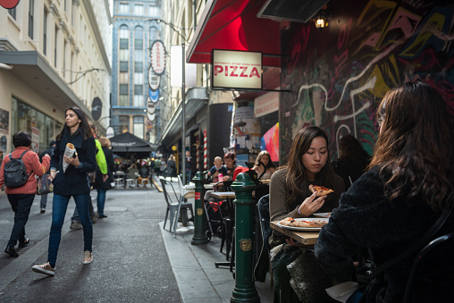 A typical busy scene with pedestrians and sidewalk dining on Degraves Street, a popular pedestrian street near Flinders Station in downtown Melbourne, Australia (September 1, 2017)
