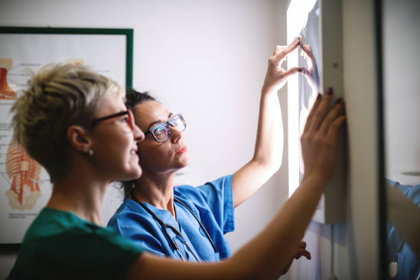istock Close up of two doctors watching x-ray image of broken bones. 1073908738