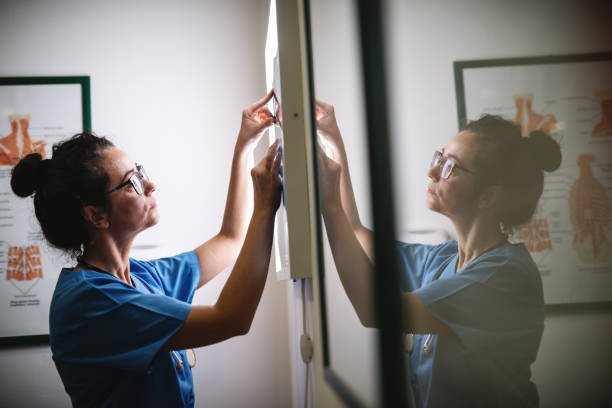 istock Female doctor looking at x-ray image with serious face. 1073908956