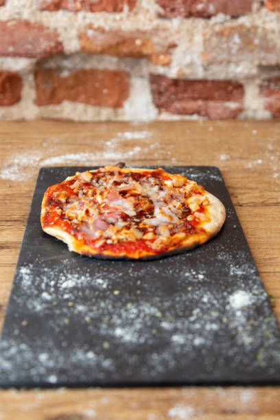 istock barbecue pizza on a blackboard garnish with flour 1073914860