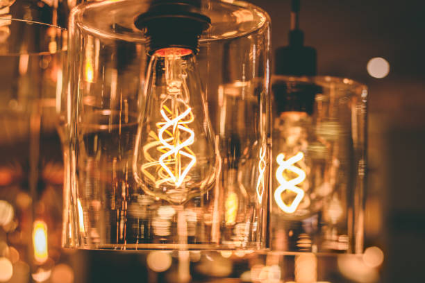 istock Close up view on a transparent modern lamp with a retro bulb inside it. 1073915246