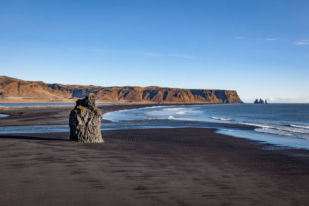 istock cape dyrholaey, arnardrangur on black sand beach, vik, iceland 1073915766