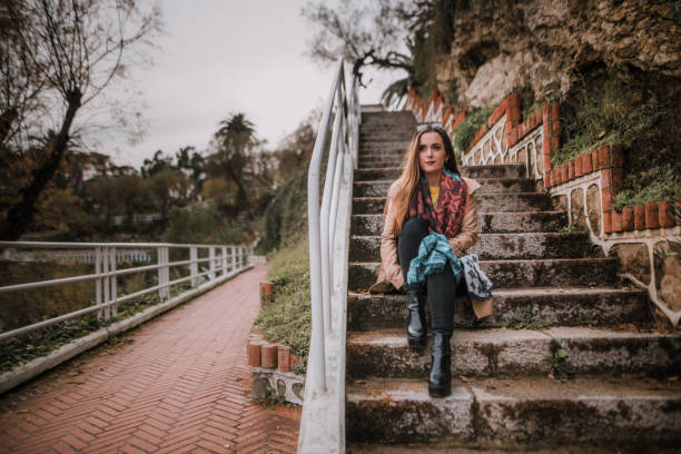 A young woman sitting at a staircase