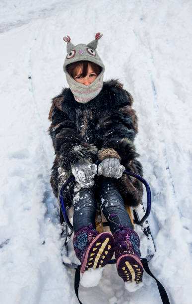 istock little girl on sledge 1073918710