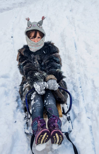 istock little girl on sledge 1073918724