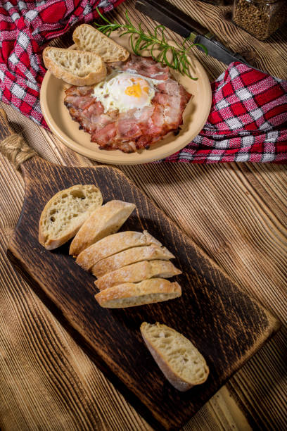 istock Plate of breakfast with fried eggs, bacon and bread. 1073927542