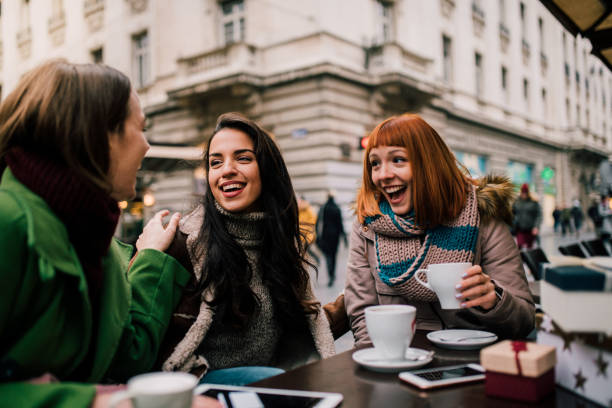 istock Happy girls drinking coffee 1073930088