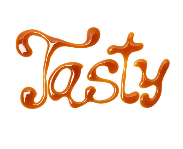 istock Word Tasty written by caramel, isolated on white background 1073933176