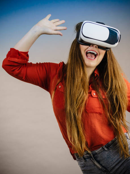 istock Girl wearing virtual reality goggles. 1073936884