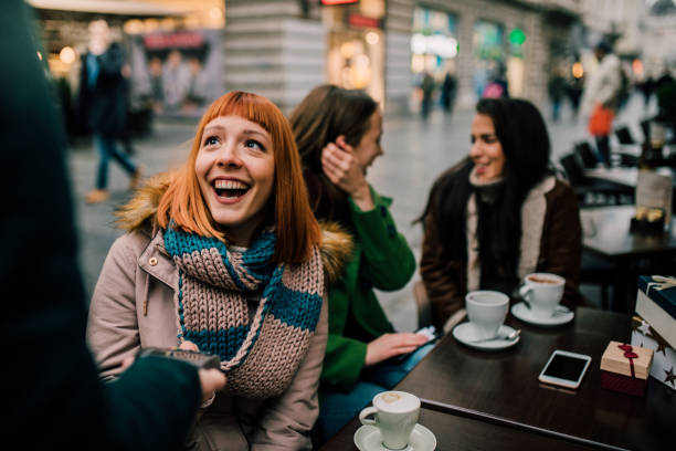 istock Smiling girl with credit card reader 1073939382