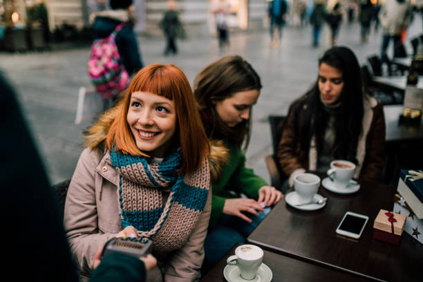 Redhead woman paying with credit card