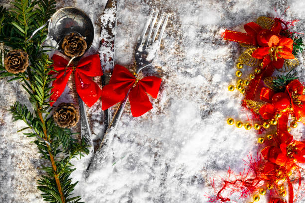 istock Christmas table set Fork, spoon and knife with decoration on snowy background 1073947060