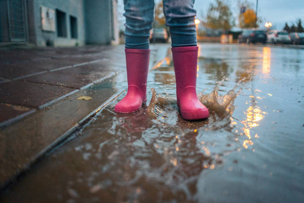 istock 3 Year old girl playing on rain 1073950136