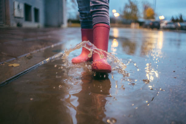 istock Little girl enjoying the rain 1073952604