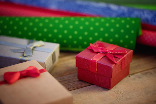 Close-up of a Christmas present (gift box) with defocused christmas lights in the background. Shallow depth of field, beautiful lights bokeh.