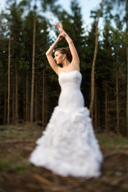 istock Lovely bride on her wedding day outdoors in a forest 1073955506
