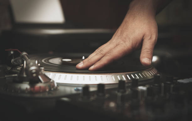 istock Hi hop dj scratches vinyl record on turn table 1073965672