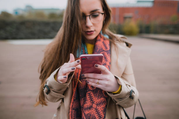 istock Young woman looking at her smartphone 1073965850