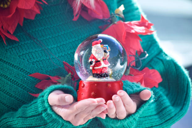 istock Girls holds Christmas snow globe 1073973290