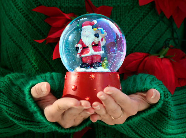 istock Girls holds Christmas snow globe 1073973292