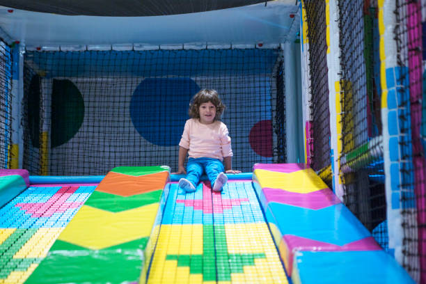 istock Smiling little Boy climbing and sliding on playground 1073973716
