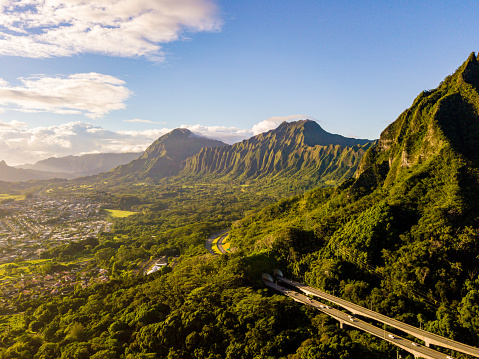Gorgeous aerial view of the Oahu green mountains view by the Ho'omaluhia Botanical Garden in Kaneohe. Mountains with famous stairs to heaven or Haiku stairs.