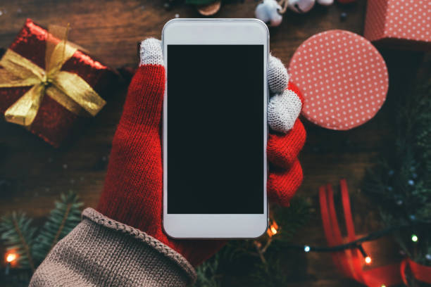 istock Smartphone in hand for Christmas season mock up 1073982866
