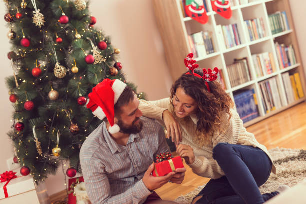 istock Couple exchanging presents on Christmas morning 1073985130