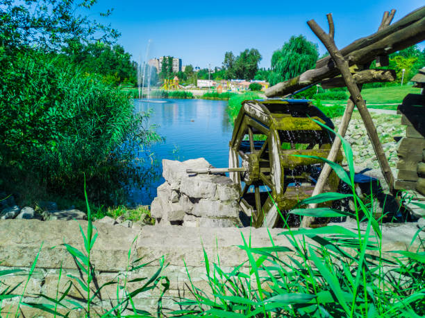 old water wheel mill in a park. zaporozhye, ukraine - august 23, 2018. - run of the mill imagens e fotografias de stock