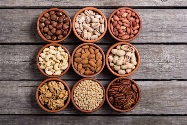 istock Mix of nuts : Pistachios, almonds , walnuts , pine nut , hazelnuts and cashew . Snack in bowl backgrond 1073985780