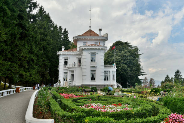 Trabzon, Turkey - September 8, 2018. Exterior view of Ataturk Mansion in Trabzon, with vegetation and people.