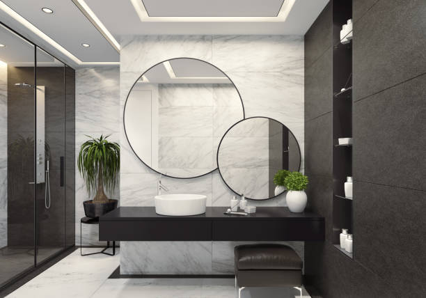istock Luxurious modern bathroom with white marble and large black tiles 1073989620