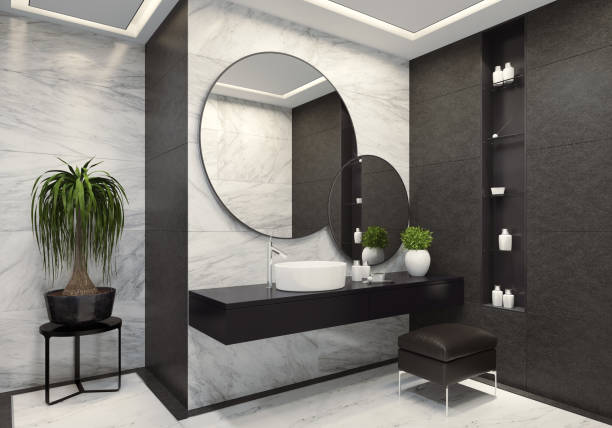 istock Luxurious modern bathroom with white marble and large black tiles 1073989638