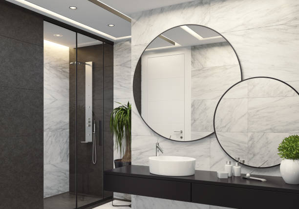 istock Luxurious modern bathroom with white marble and large black tiles 1073989664