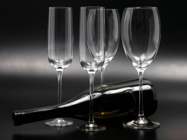 istock four empty wine glasses and a reclining wine bottle 1073989998