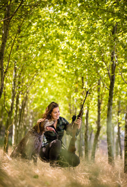 Autumn hunting season. Hunting. Outdoor sports. Woman hunter in the woods