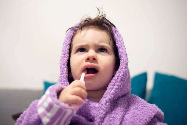 istock Angry Little Girl With a Toothbrush 1073992580