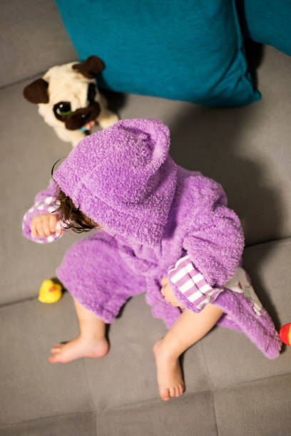 istock Baby Girl in a Pink Bathrobe 1073992592