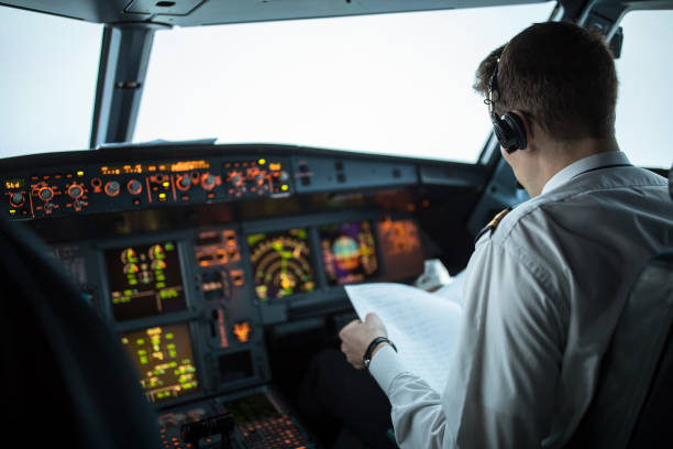 pilot  in  a commercial airliner airplane flight cockpit during takeoff - airplane cockpit taking off pilot imagens e fotografias de stock