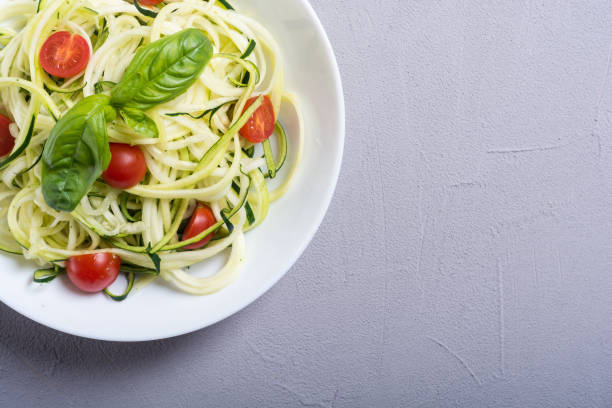 istock Zucchini pasta noodles with tomatoes . Healthy vegetarian food 1073995708