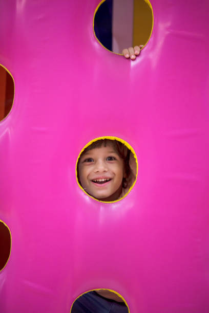 istock Little Happy Boy Looking Through Playhouse Window. 1074009946