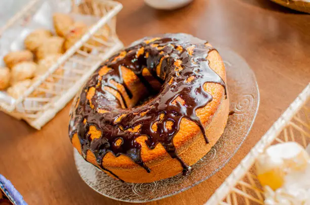 Photo of chocolate covered vanilla cake arranged on a coffee table