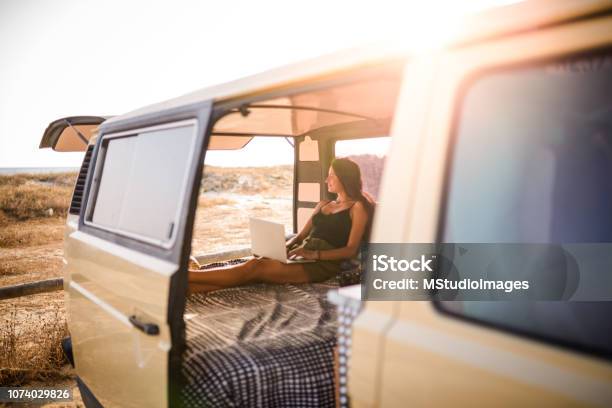 Woman Using Laptop Stock Photo - Download Image Now - Travel, Van - Vehicle, Journey