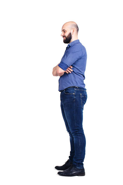 istock A young bearded guy stands sideways and looking down. Isolated on white. 1074030224