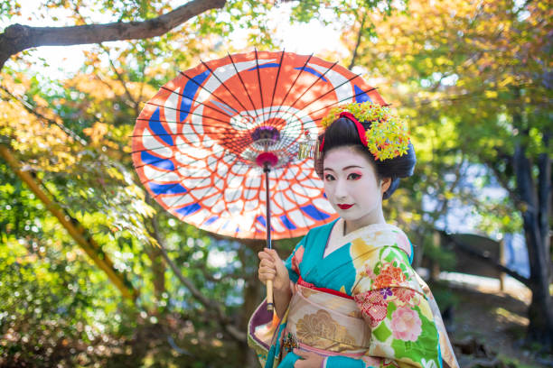 istock Maiko Apprentice Geisha posing in nature 1074030498