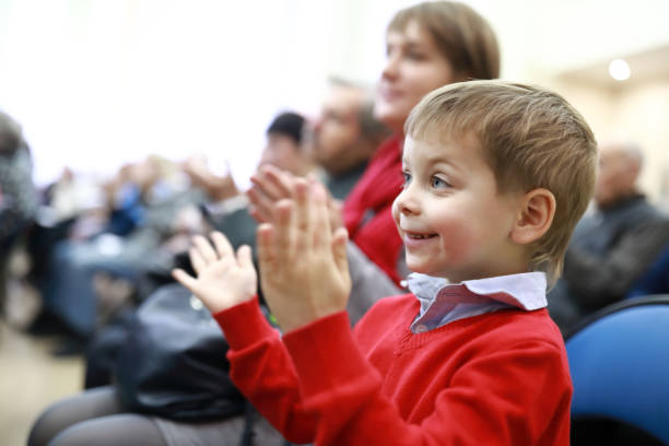 istock Kid applauds in theater 1074032100