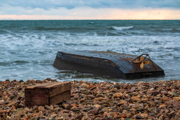 istock A storage box is lying on the shore next to an inverted boat after a shipwreck due to typhoon 1074039204