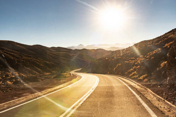 Desert highway and mountains. The road goes the distance. Perfectly smooth highway across the endless desert. Watercolor illustration on the theme of travel.